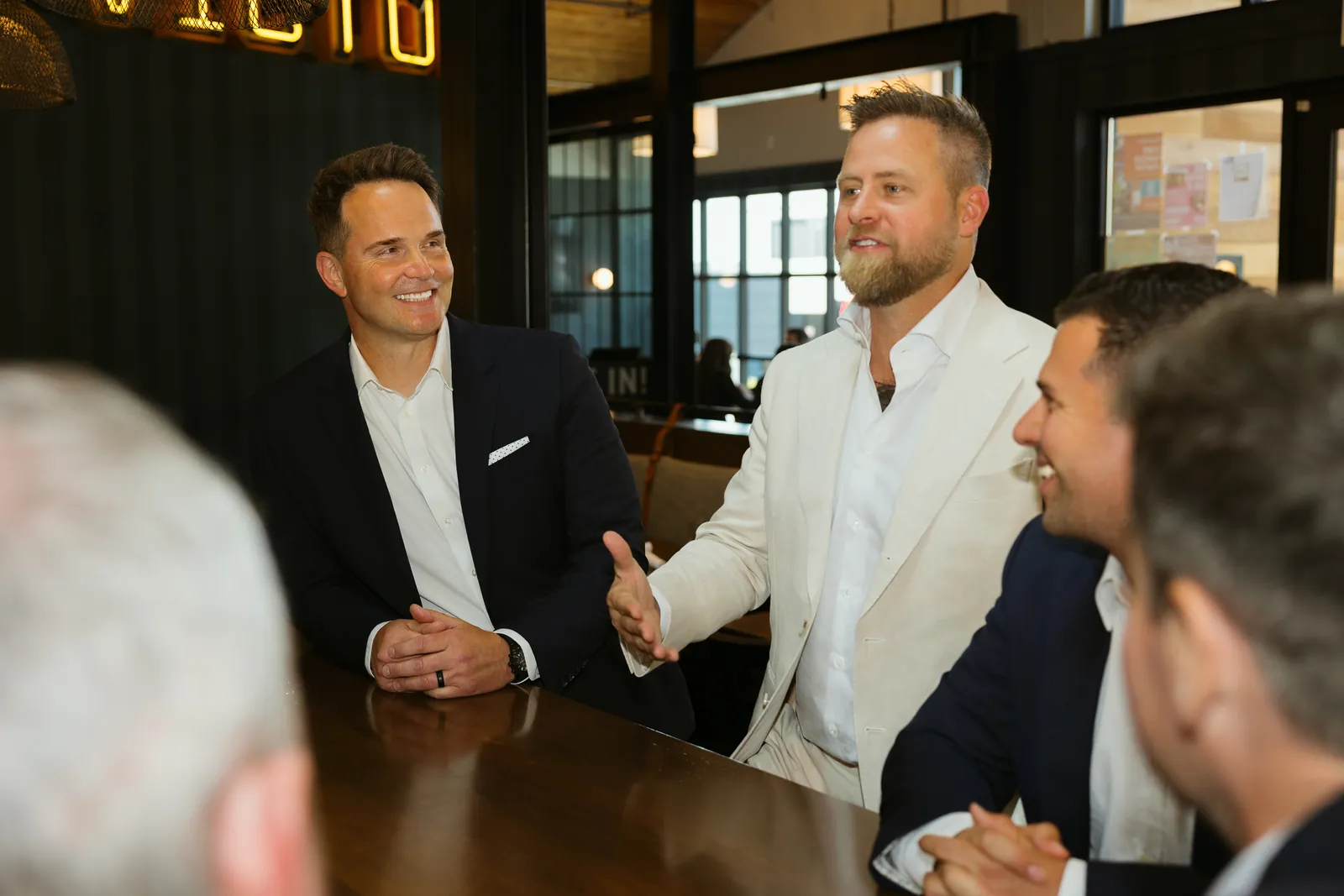 McConnell Group agents laughing around a table